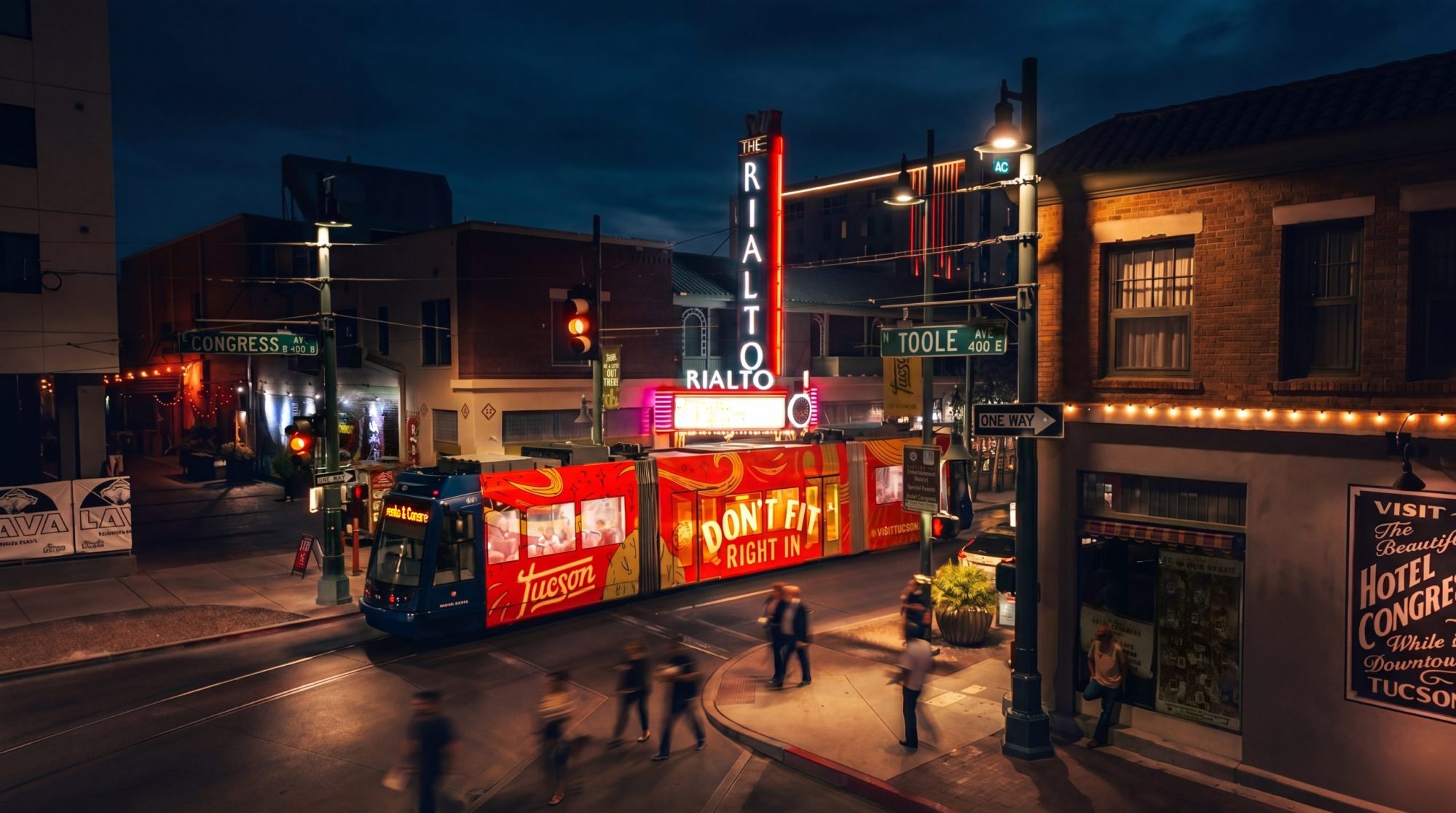 A Tucson streetcar rolls past the Rialto Theatre on Congress Street at night, illustrating downtown’s lively nightlife and transit options.