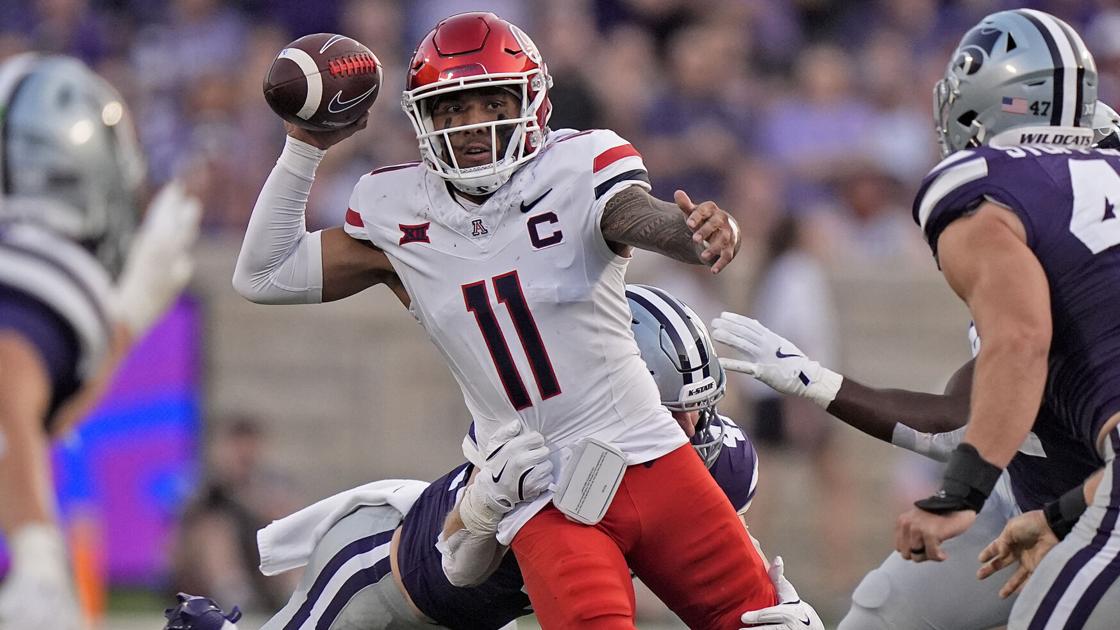 Arizona quarterback under pressure during game action — representative Wildcats imagery for the article detailing 2026 kickoff times and television assignments.