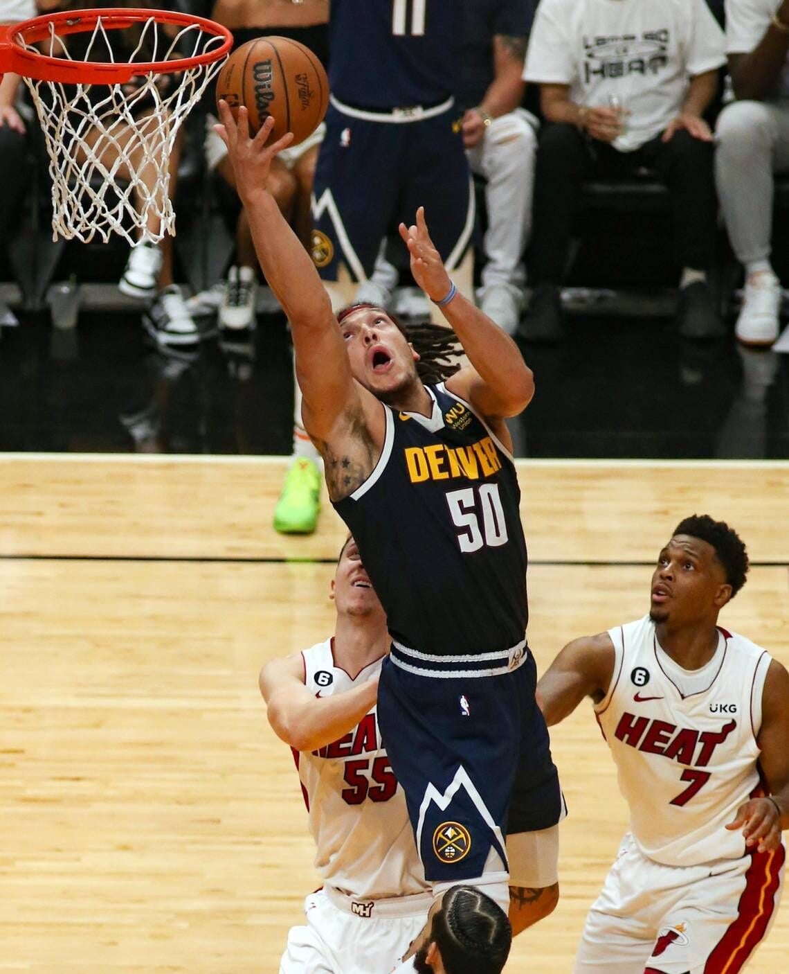 Denver Nuggets forward (No. 50) goes to the rim in a postseason game; another Arizona-connected player highlighted in Finals coverage.