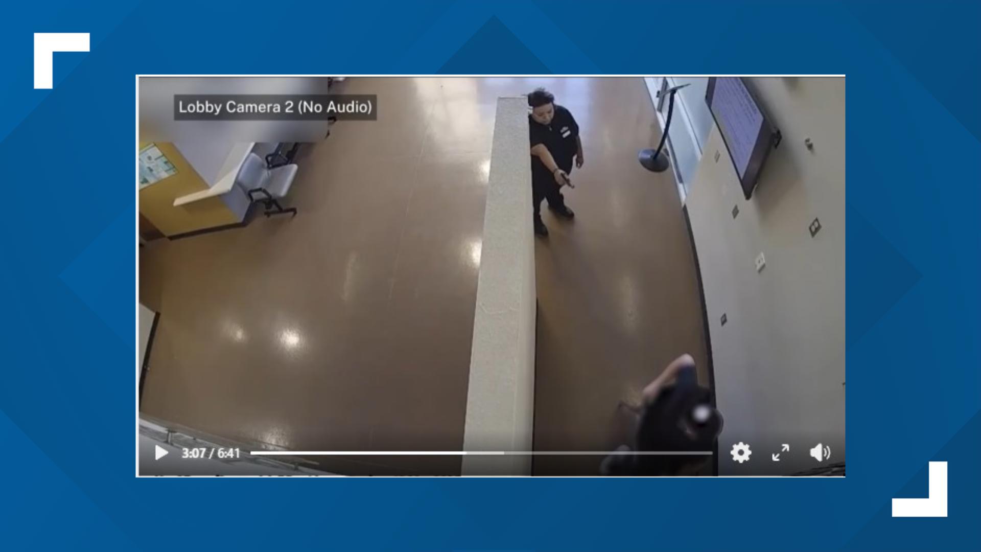 Surveillance still from a lobby camera appearing to show an individual pointing a gun during the incident; footage included in the 12News report.