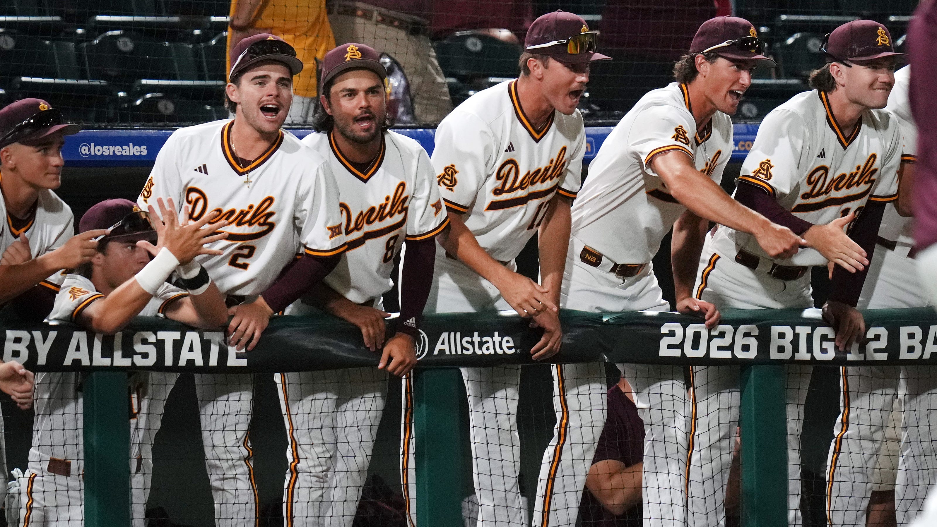 Arizona State players cheer from the dugout, rallying together as the team prepares for its upcoming game against Ole Miss.