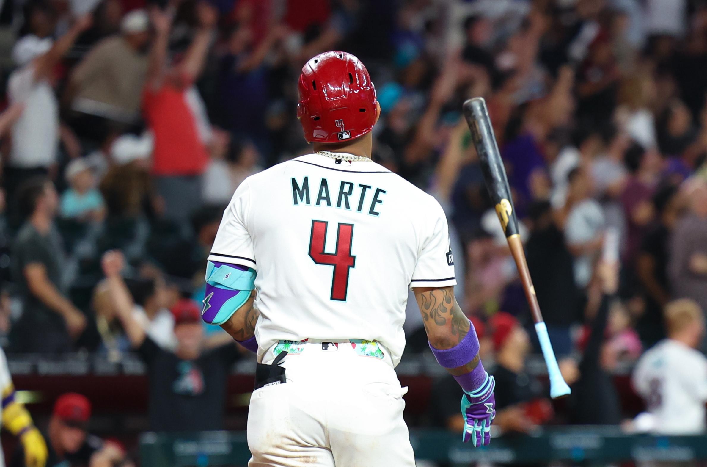 A Diamondbacks hitter stands in the batter’s box with the crowd behind him as Arizona aims to respond in the Marlins series.