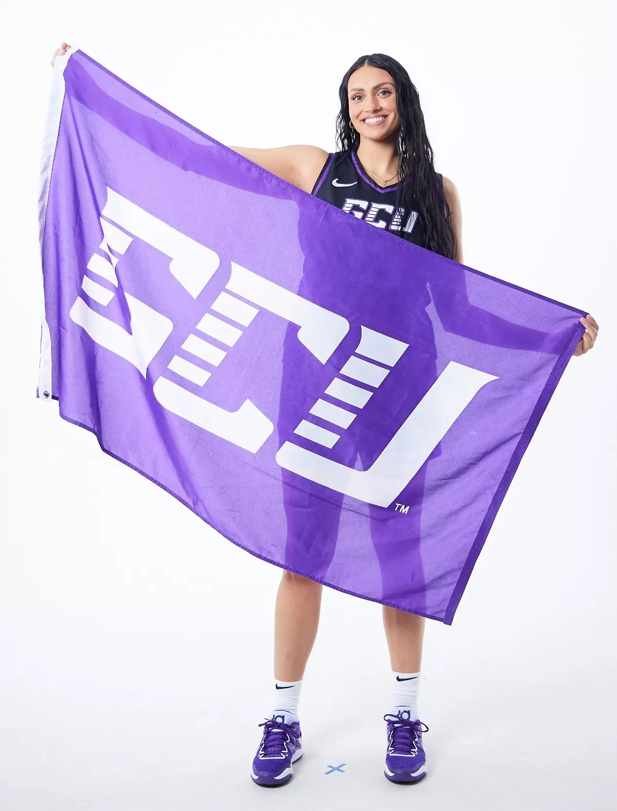 Chlarson holds a large GCU flag during photo day — the small‑town addition from Pima, Ariz., joins the Lopes with high expectations.