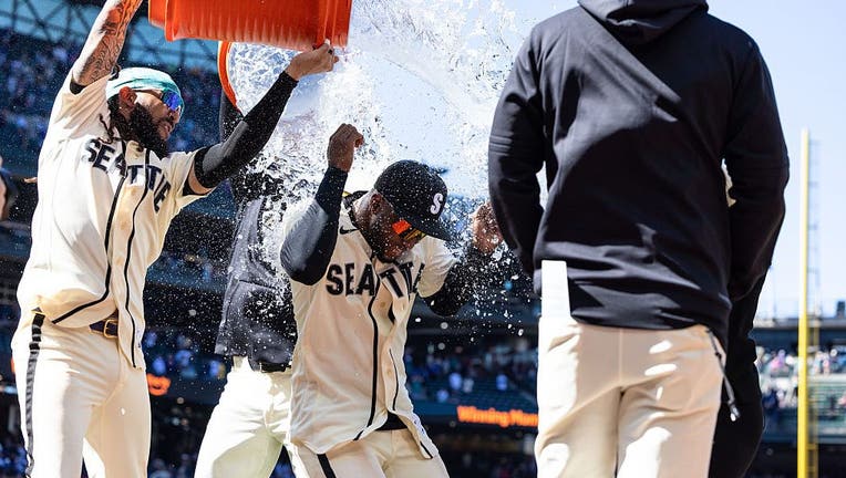 Seattle Mariners celebrate with a Gatorade dousing after the victory that completed a three-game sweep of the Diamondbacks.