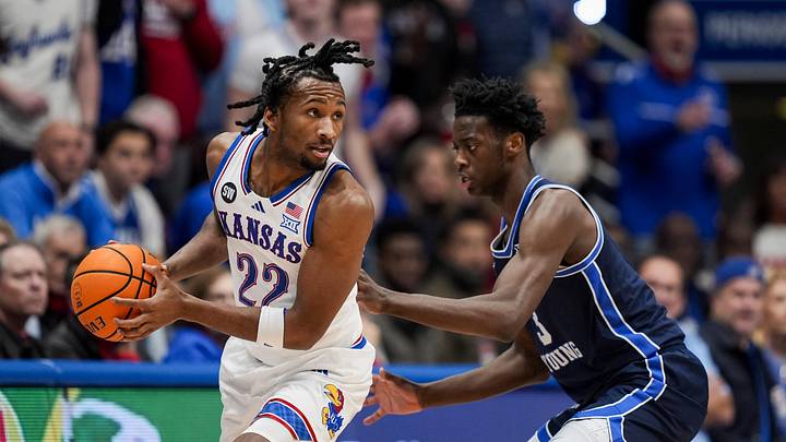 BYU’s No. 3 defends Kansas’ ball-handler in a Big 12 matchup, showing the perimeter defense and physicality Washington would evaluate as it considers how to help the young prospect meet his goals.