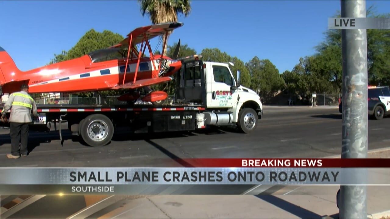 Tow truck loads the red biplane after it was removed from a Tucson southside roadway following the crash; police remained on scene.
