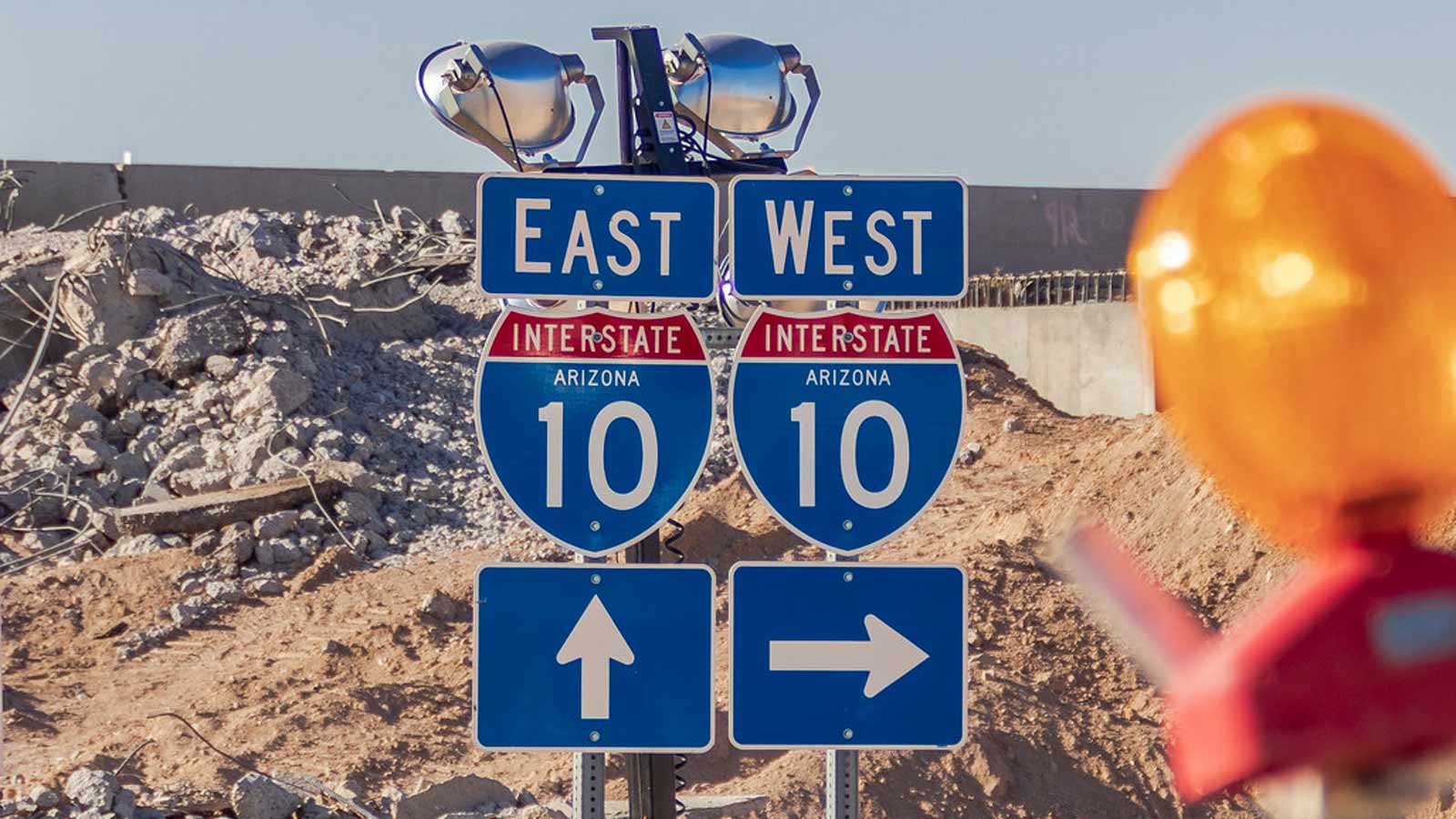 Interstate 10 east/west directional signs at a Phoenix work site, highlighting the corridor affected by weekend construction closures and detours.