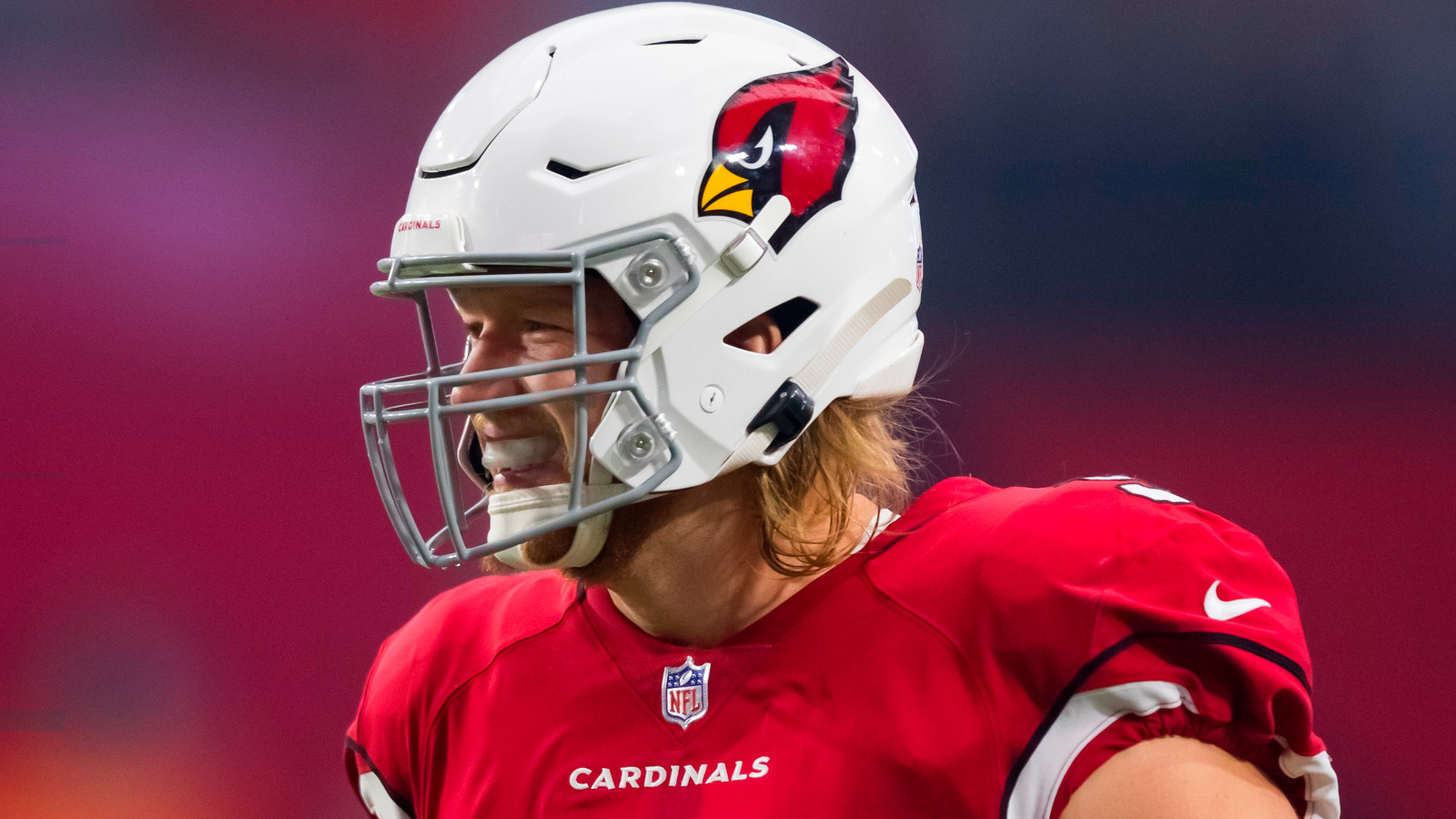 Josh Mauro wearing an Arizona Cardinals helmet and red jersey during a game; the Maricopa County medical examiner determined he died from an accidental overdose.