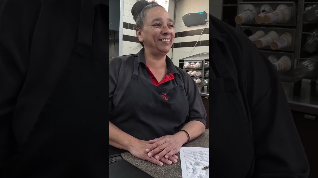 A Dairy Queen employee in uniform behind the counter at the Picacho Peak location on the travel center’s final day of operation.