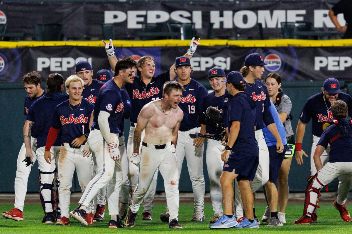 Ole Miss teammates swarm and celebrate on the field after the walk‑off victory over Arizona State to advance to the super regional.