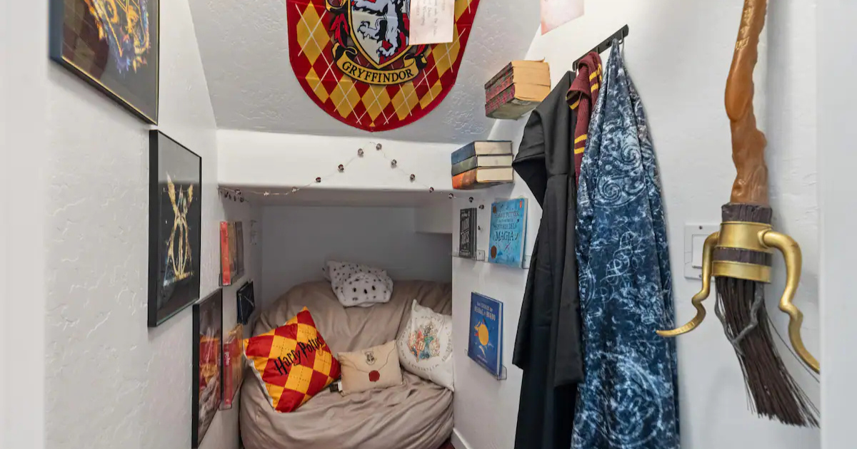 A cozy 'cupboard under the stairs' nook at the Arizona rental, dressed with Gryffindor décor and wizarding props for an immersive Harry Potter stay.