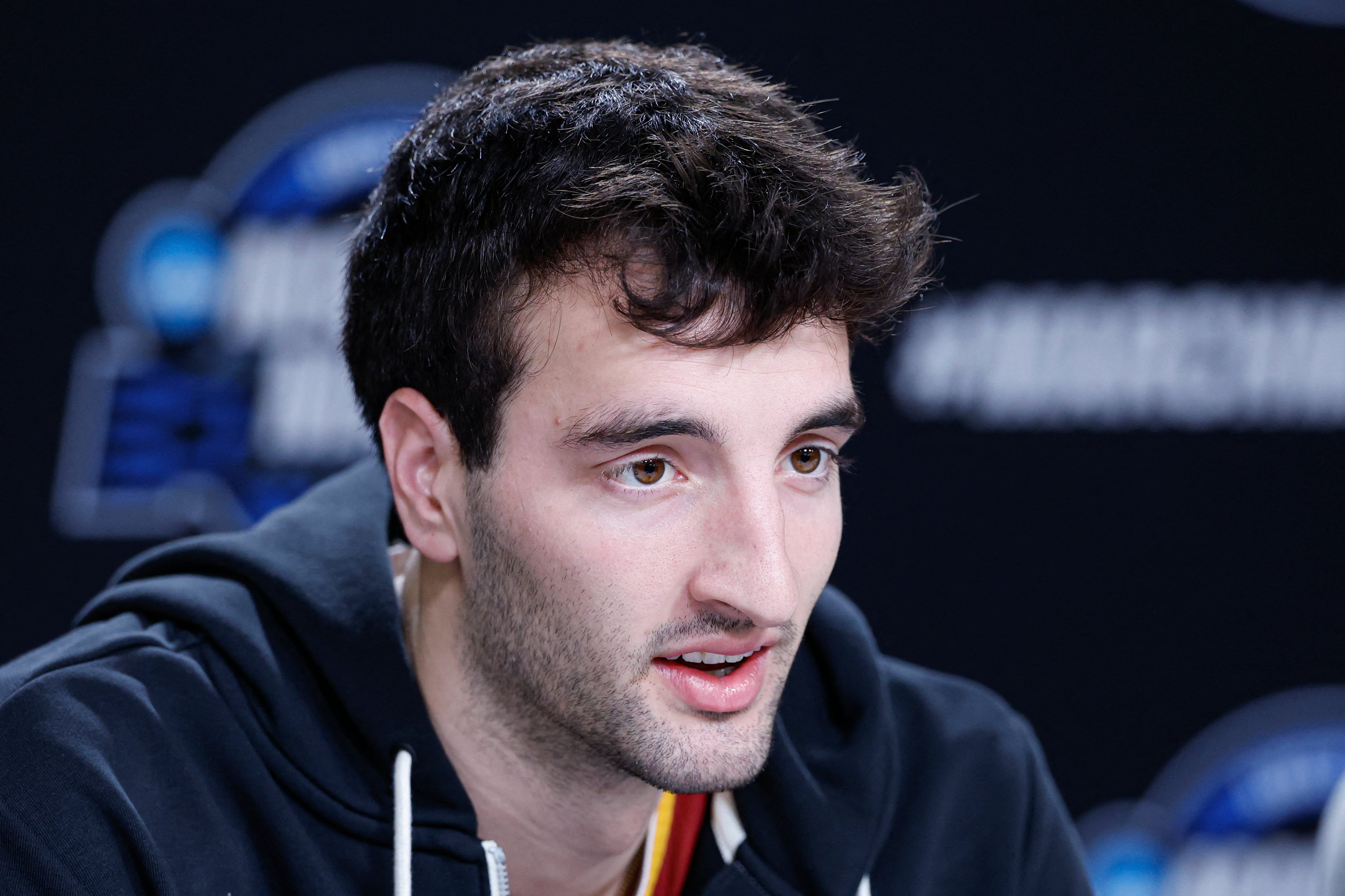 Milan Momcilovic speaking to media at a team availability; the Iowa State transfer has Arizona among his final three suitors.