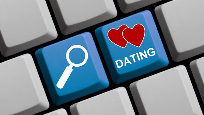 Illustration of keyboard keys labeled 'DATING' with a magnifying glass and hearts, representing online dating and romance scams referenced in the story.