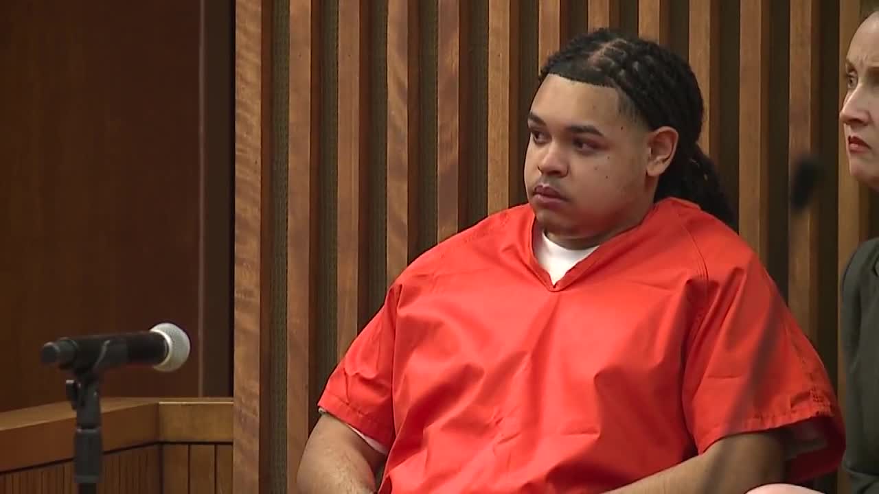 Courtroom photo of a defendant in an orange jail uniform seated during a sentencing hearing related to the 2024 drive-by shooting.