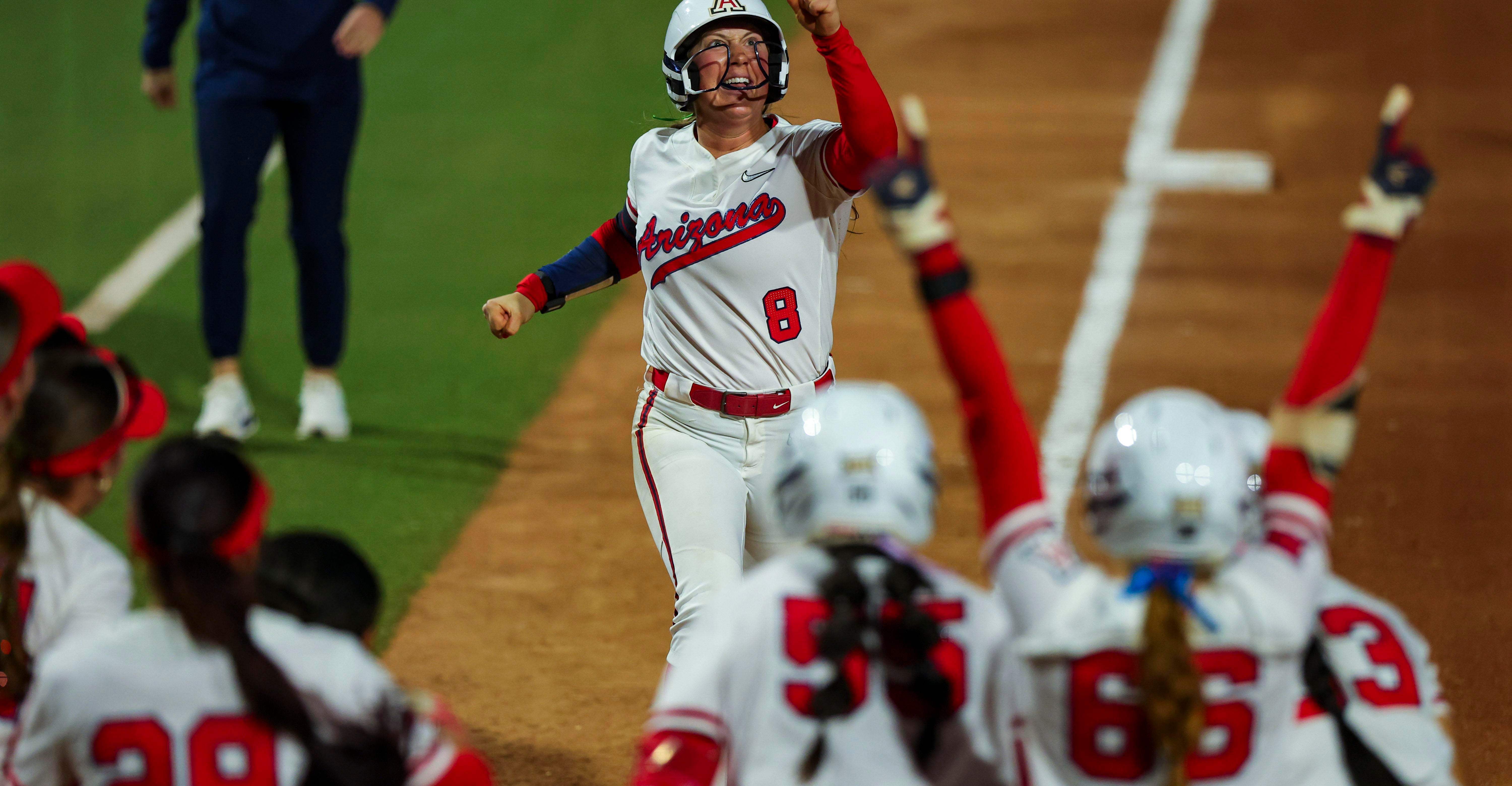 Arizona’s No. 8 pumps a fist as teammates cheer in the dugout after a decisive moment during the Wildcats’ win that pushed Duke into the losers’ bracket.