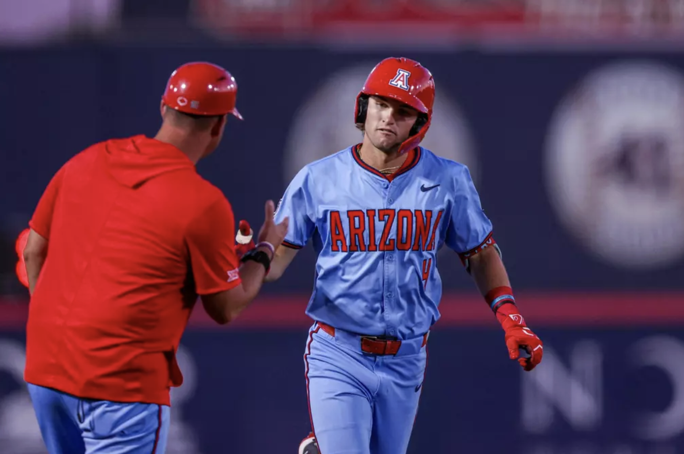 An Arizona player rounds the bases and receives a coach’s acknowledgement during a game — representative of the individual contributors referenced in offseason roster coverage.