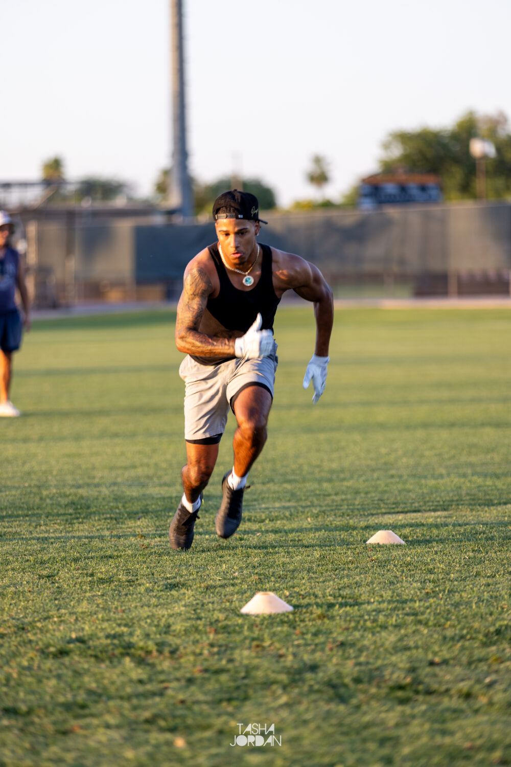 A Utah receiver works through route‑running cones in Arizona drills run as part of Devon Dampier’s offseason training for the group.