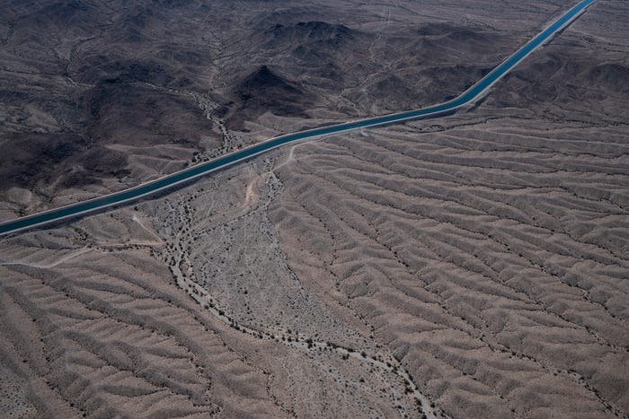 Aerial photo of the CAP canal winding across the Arizona desert, illustrating the 336-mile aqueduct that carries Colorado River water to central and southern Arizona.