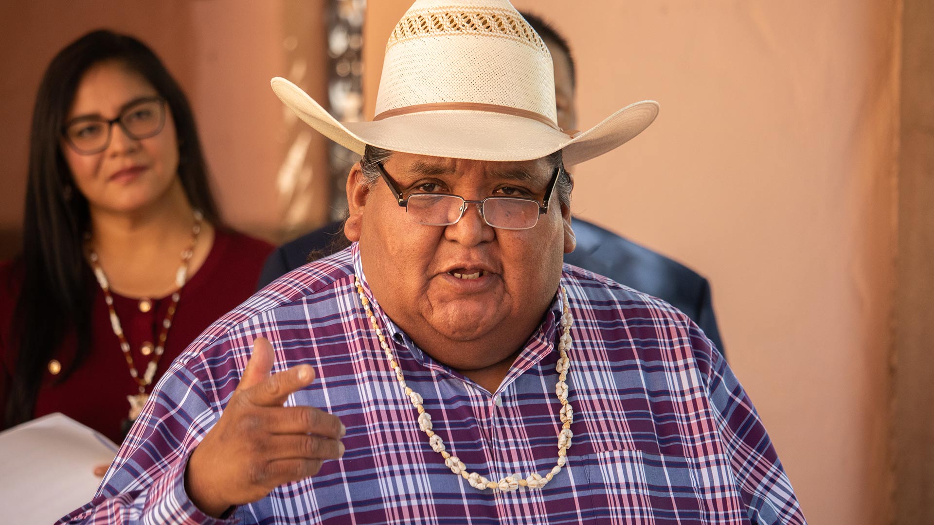 A tribal representative addresses reporters at the Tucson event, calling for the IHS to halt the proposed office closure until affected tribes have been meaningfully consulted.