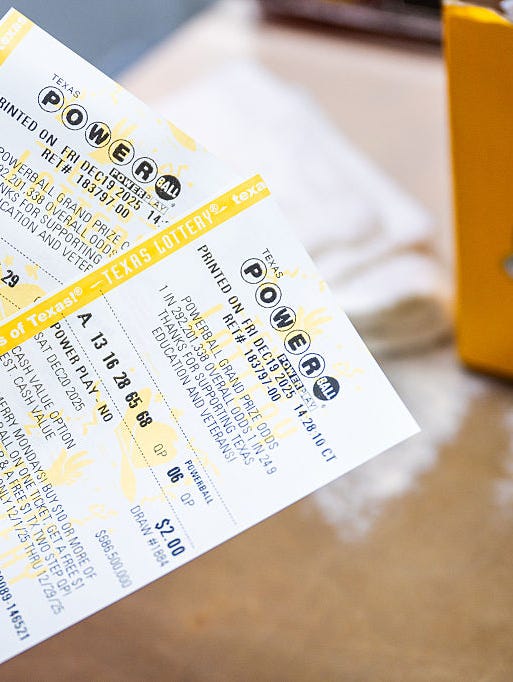 Powerball lottery tickets held at a retail counter; Arizona players are reminded to check their tickets against the June 5, 2026 drawings, including Mega Millions and Pick 3.