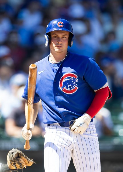 The 19-year-old phenom walks with his bat between at-bats in a Cubs jersey, a quieter portrait from the same game.