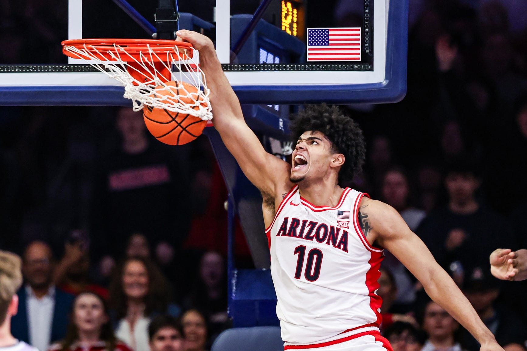 Arizona forward Koa Peat (No. 10) powers a dunk in game action for the Wildcats; Peat is leaving Arizona to pursue the 2026 NBA Draft.