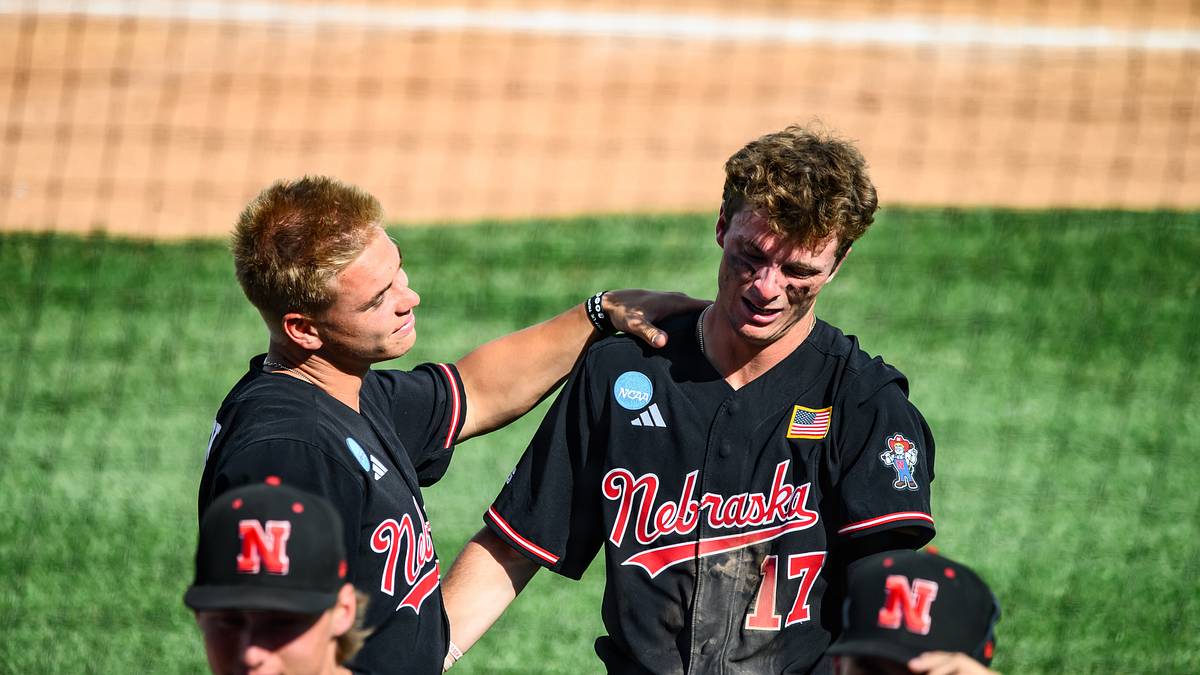 Nebraska players console one another after the Cornhuskers' 11-8 elimination loss to Arizona State in the Lincoln Regional; No. 17 is visibly emotional as the season ends.