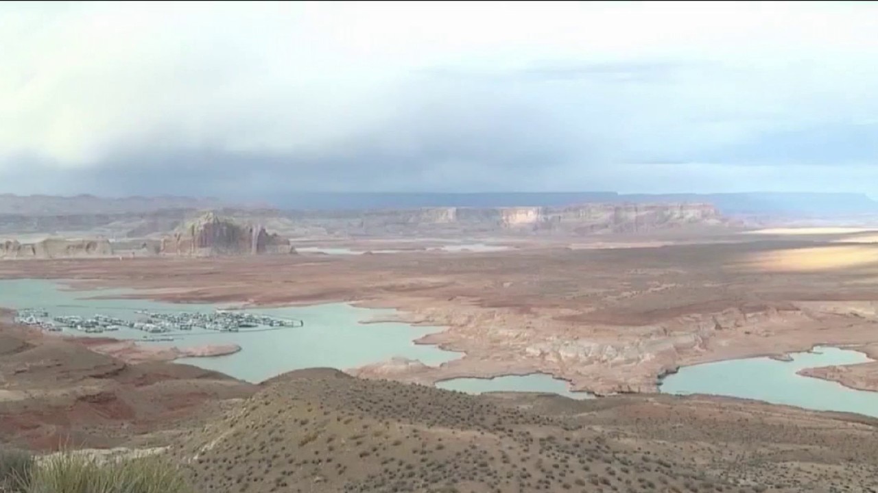 Aerial view of a Colorado River reservoir with exposed shoreline and reduced water, illustrating the urgency behind proposals to send more river water to Arizona.
