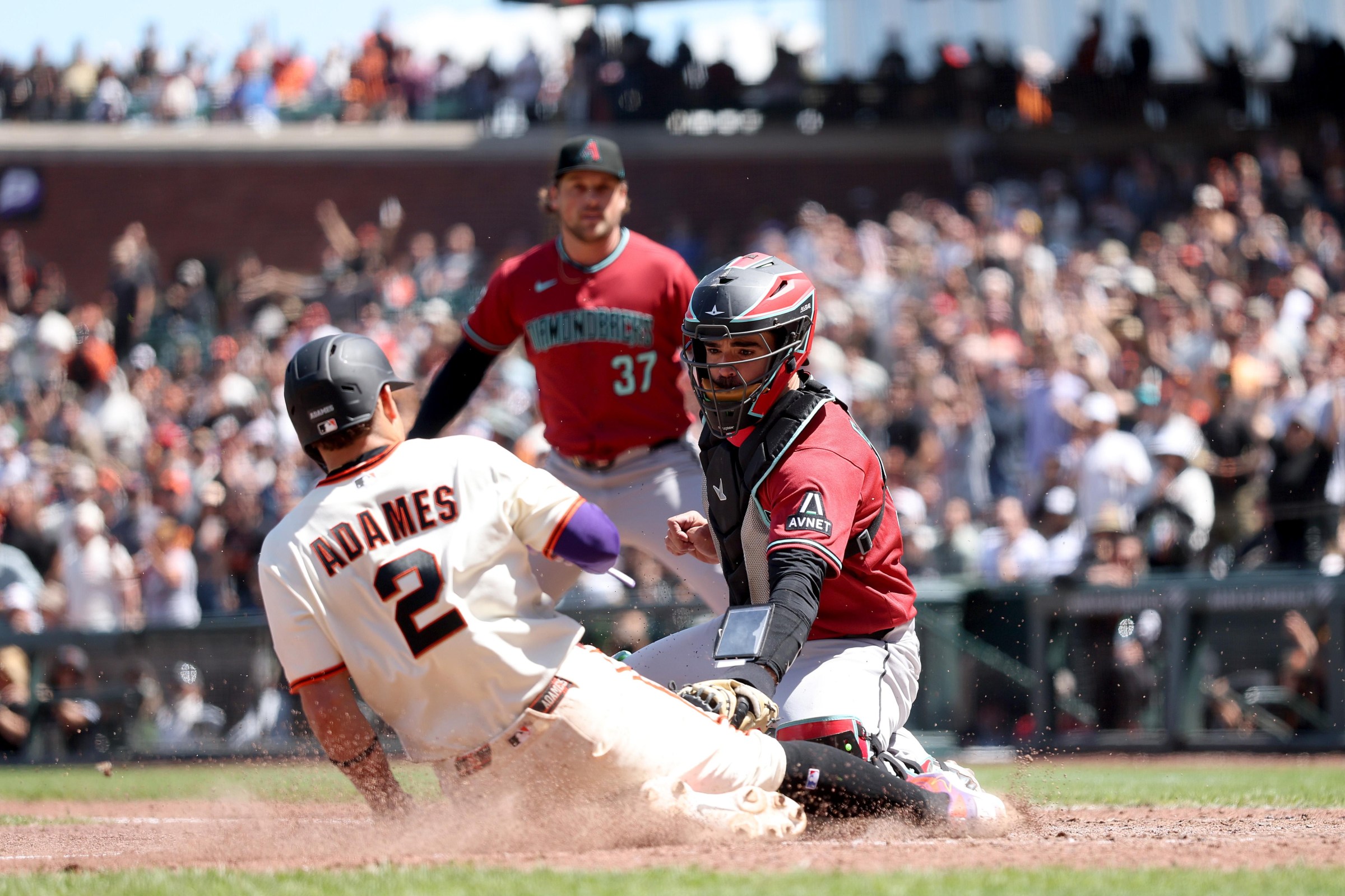 Arizona catcher converges on a close play at the plate during a tense series as the Diamondbacks try to steady their June form.